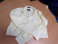 A pale yellow long sleeve button up shirt
